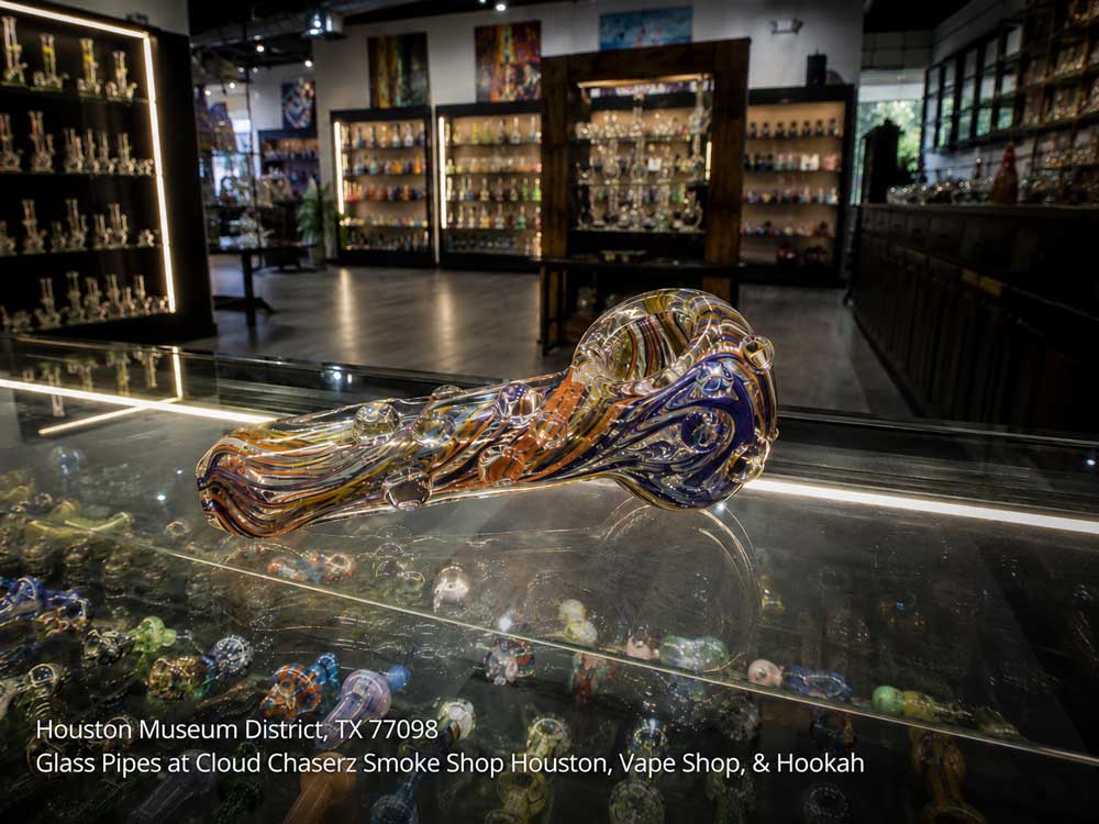 Colorful handblown glass pipes at a Houston boutique vape shop with fully stocked shelves.