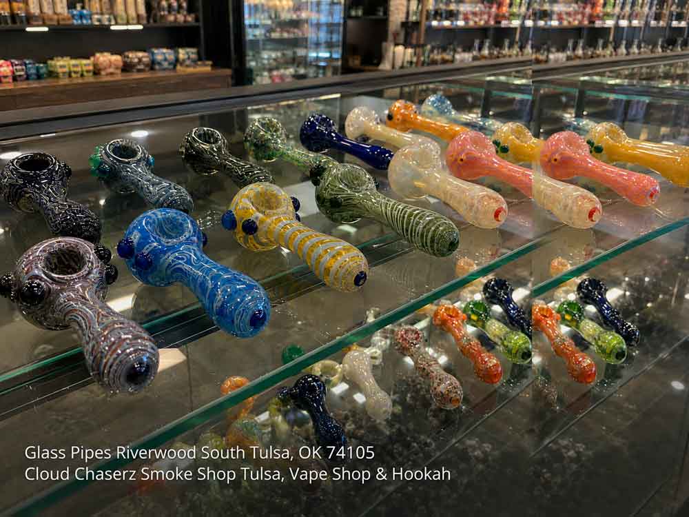 Display case filled with diverse glass pipes Tulsa smoke shops offer, featuring rows of colorful hand-blown designs.