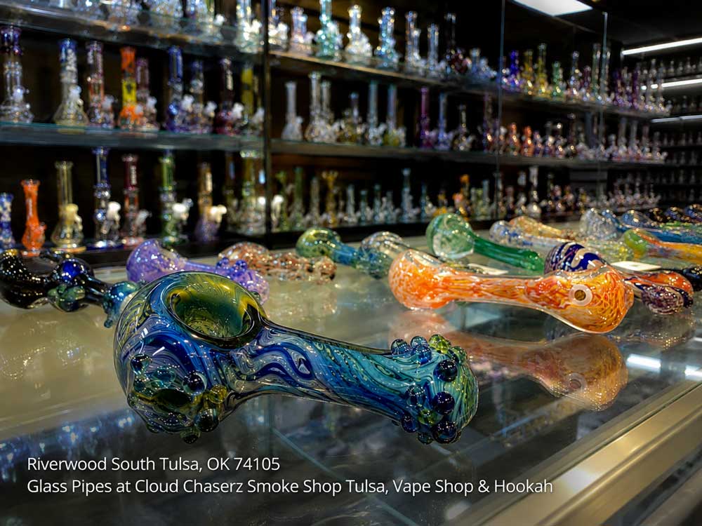 Selection of vibrant glass pipes Tulsa residents find at local smoke shops, highlighting a blue swirl spoon pipe.