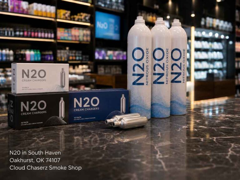 Large nitrous oxide tanks and 10-packs of N20 Sapulpa cream chargers on a marble counter at a smoke shop.