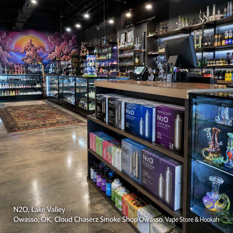 Indoor shelves stocked with N2O cream chargers and vaping supplies inside an Owasso smoke shop location.