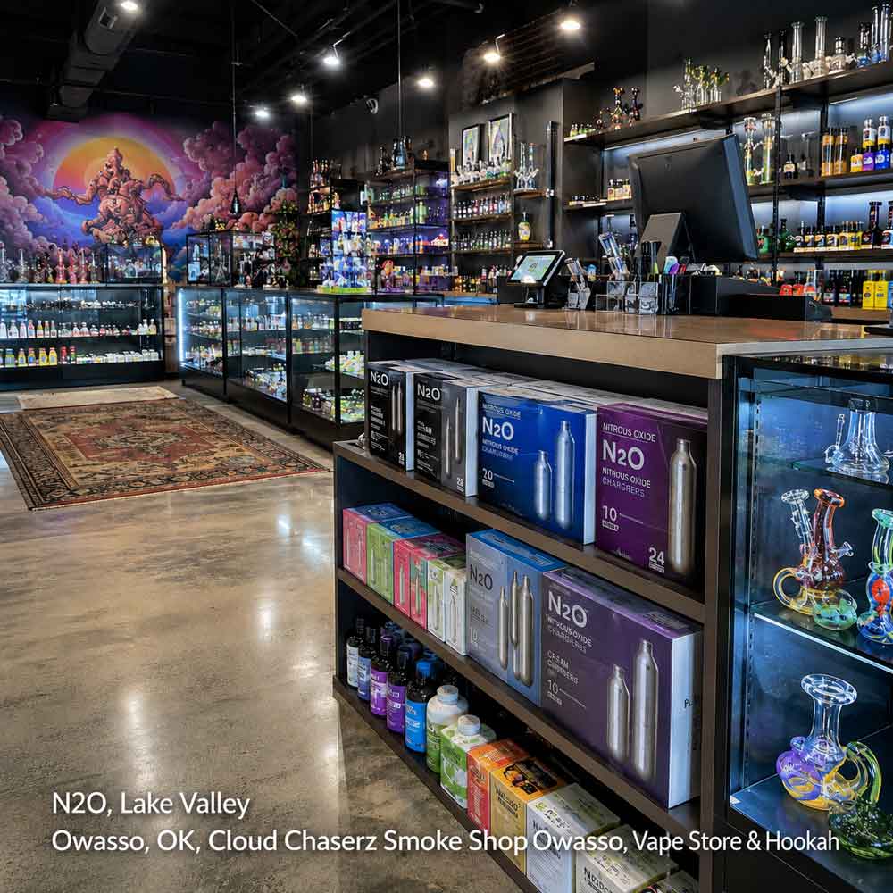 Indoor shelves stocked with N2O cream chargers and vaping supplies inside an Owasso smoke shop location.