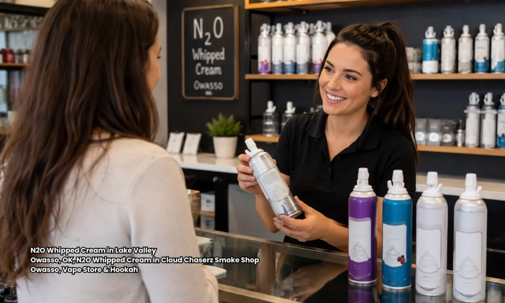 Friendly shop assistant offering N2O whipped cream canisters to a customer inside Cloud Chaserz in Owasso Oklahoma