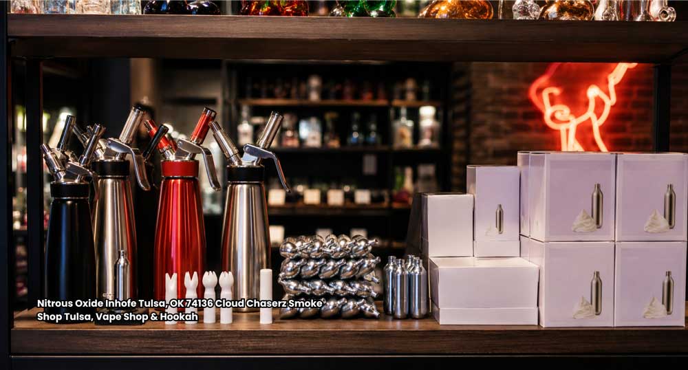 Store clerk demonstrating whipped cream dispensers for nitrous oxide chargers available at Cloud Chaserz in Tulsa, OK.