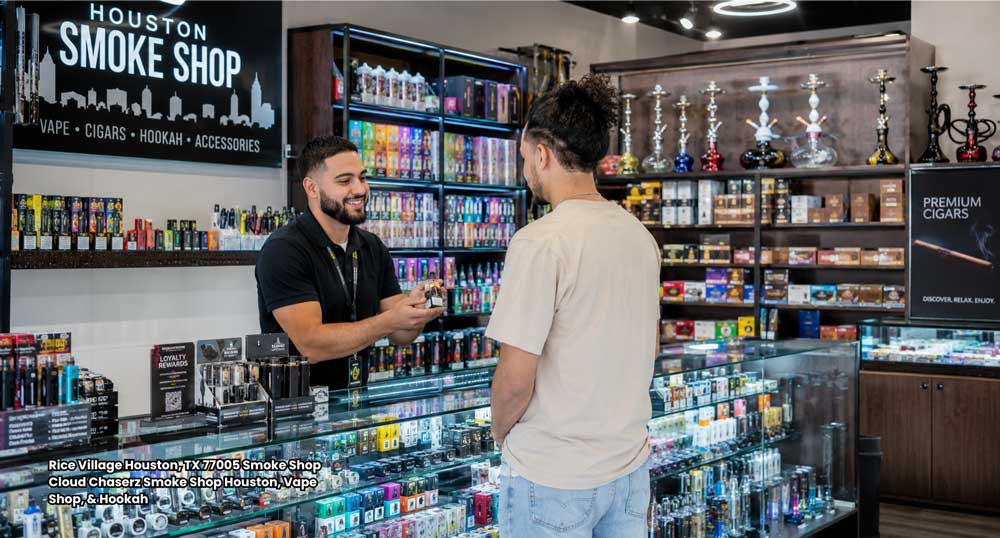 Store employee assisting a customer at Cloud Chaserz vape and smoke shop counter in Rice Village Houston Texas area.