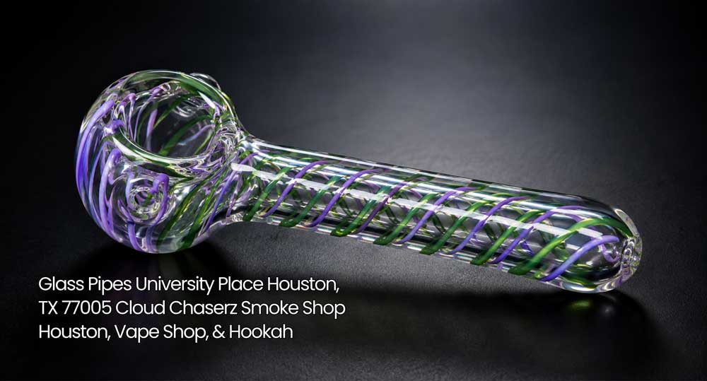Clear glass pipe with vivid purple and green inner swirls on dark background at Cloud Chaserz glass pipes Houston.