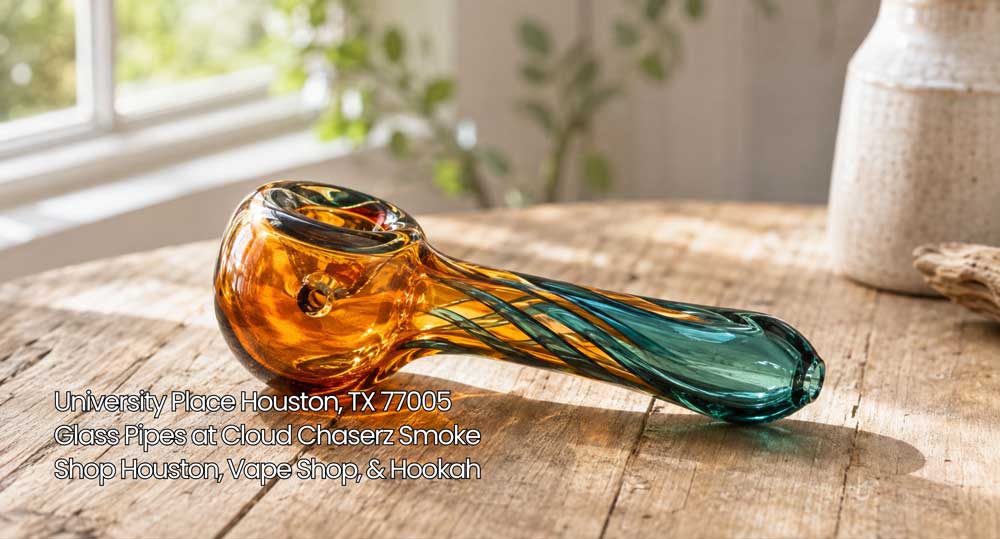 Handcrafted amber and teal swirled glass pipe on a rustic wooden surface at Cloud Chaserz glass pipes Houston.
