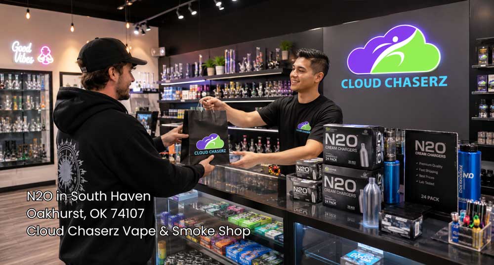 Customer receiving a purchase at the Cloud Chaserz counter, with n2O Sapulpa cream chargers displayed in a clean smoke shop.