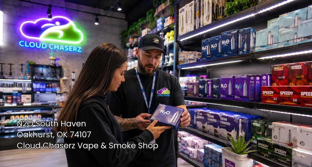 Shopper comparing cream charger options with an employee inside Cloud Chaserz, highlighting n2O Sapulpa products on display.