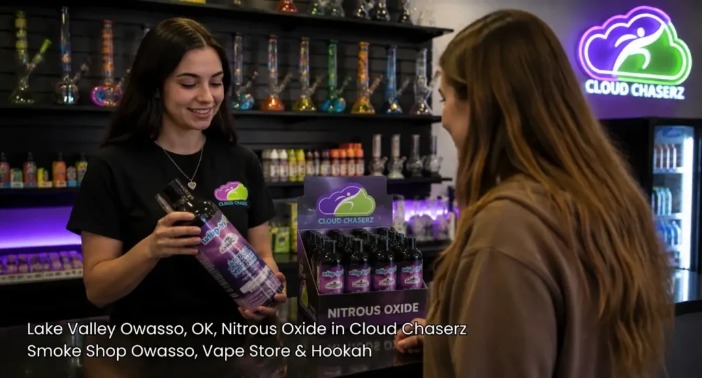 Store clerk showing a canister product to a customer looking for nitrous oxide Owasso items in Cloud Chaserz.