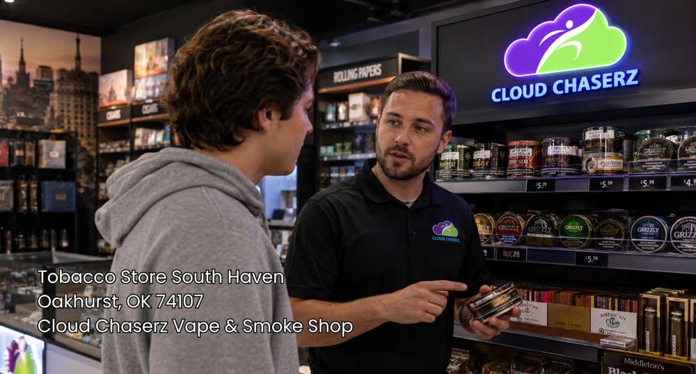 Store employee explaining tobacco products to a customer inside Cloud Chaserz, a tobacco store Sapulpa shoppers can visit.