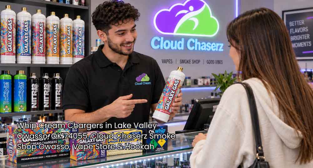 Store clerk showing a customer Galaxy Gas whip cream chargers Owasso inventory inside Cloud Chaserz vape shop.